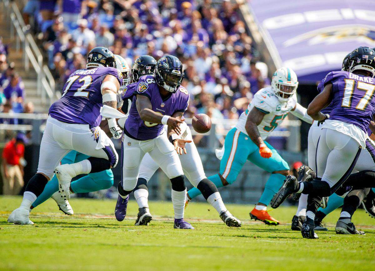Baltimore Ravens quarterback Lamar Jackson (8) toss the football to running back Kenyan Drake (17) during first quarter of an NFL football game against the Miami Dolphins at M&T Bank Stadium on Sunday, September 18, 2022 in Baltimore, MD.