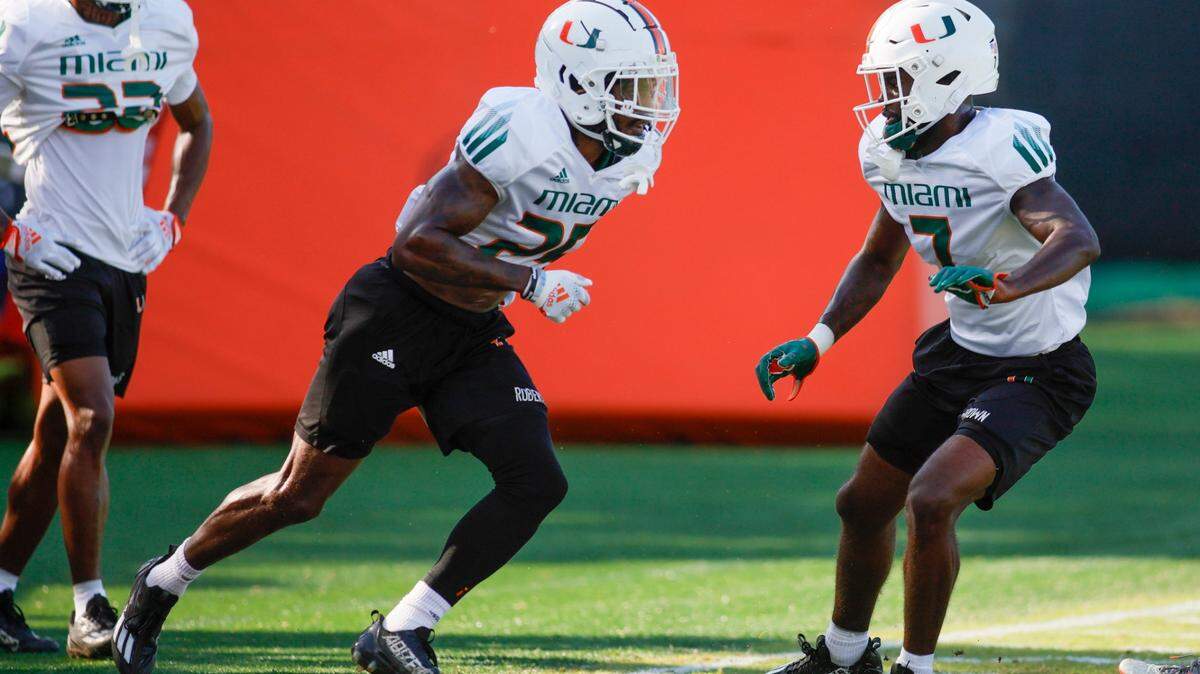 Miami Hurricanes cornerback Terry Roberts (25) and defensive back Davonte Brown (7) work out during football practice at the University of Miami campus in Coral Gables, Florida, Tuesday, April 4, 2023.