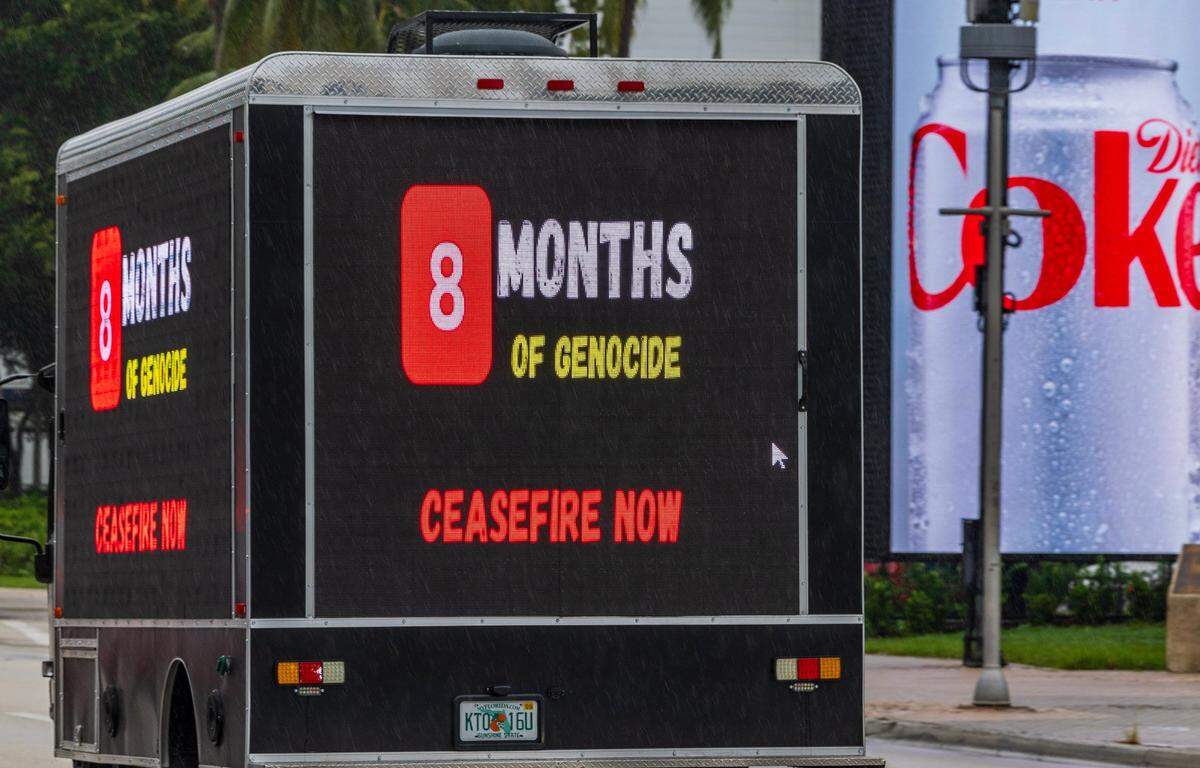 An add truck drove by as a group of people protested in support of the Palestinians in Gaza in downtown Miami.