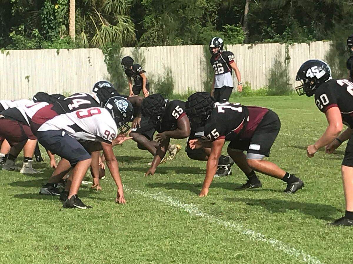 To minimize severe injuries through hard contact, Braden River High players wear soft-covered guardian caps over their football helmets, which uses InSite technology to monitor impacts at Monday’s practice held Aug. 26, 2019.