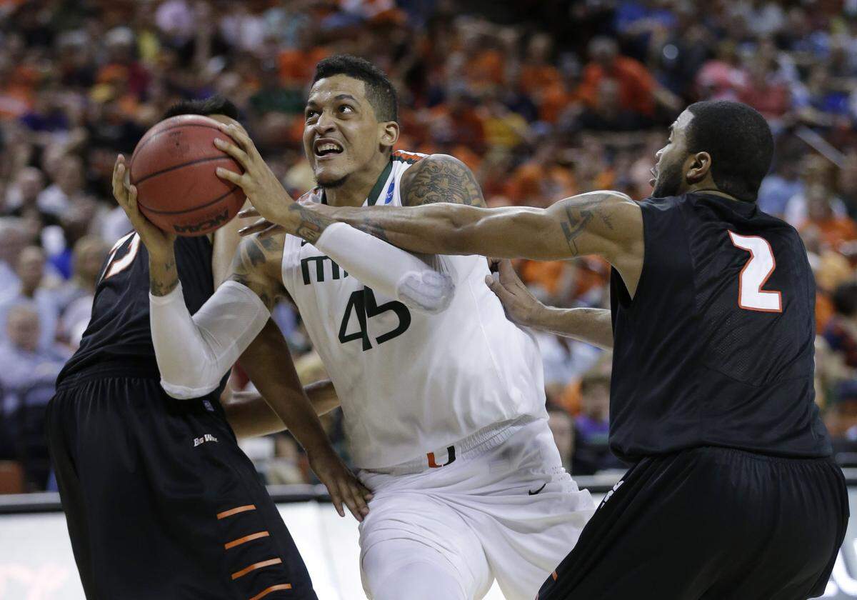 Miami’s Julian Gamble (45) drives past Pacific’s Colin Beatty (2) during the second half of a second-round game of the NCAA college basketball tournament Friday, March 22, 2013, in Austin, Texas. Miami beat Pacific 78-49. (AP Photo/Eric Gay)