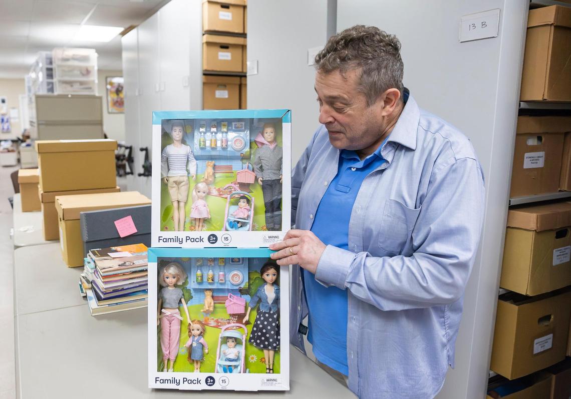 Robert Kesten, the executive director of the Stonewall National Museum, Archives and Library, is photographed inside of the museum’s archives holding children’s toys that were sold at a Walmart in Australia and depict same-sex marriages.