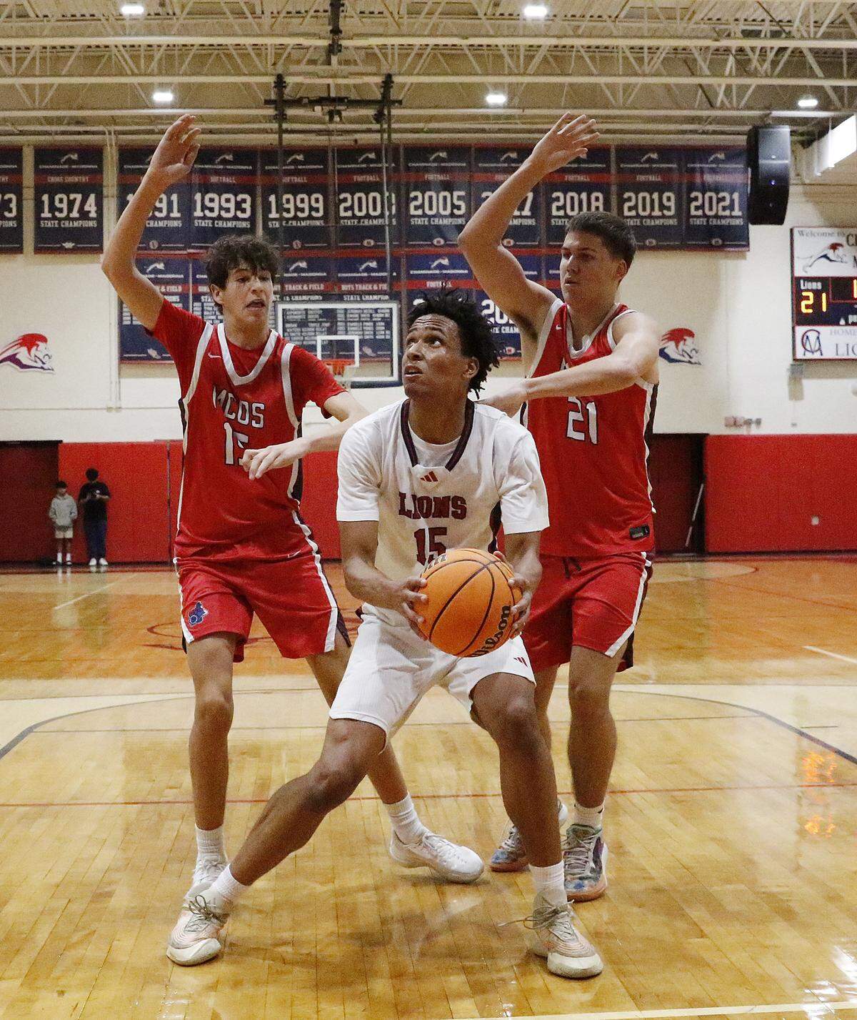 Chaminade-Madonna Lions Tristan Sylvera (15) tries to shoot while being tightly guarded by Miami Country Day Spartans during the Region 4-2A quarterfinal boys basketball game on Saturday, February 14, 2026 at Chaminade-Madonna School in Hollywood. Andrew Uloza / for Miami Herald