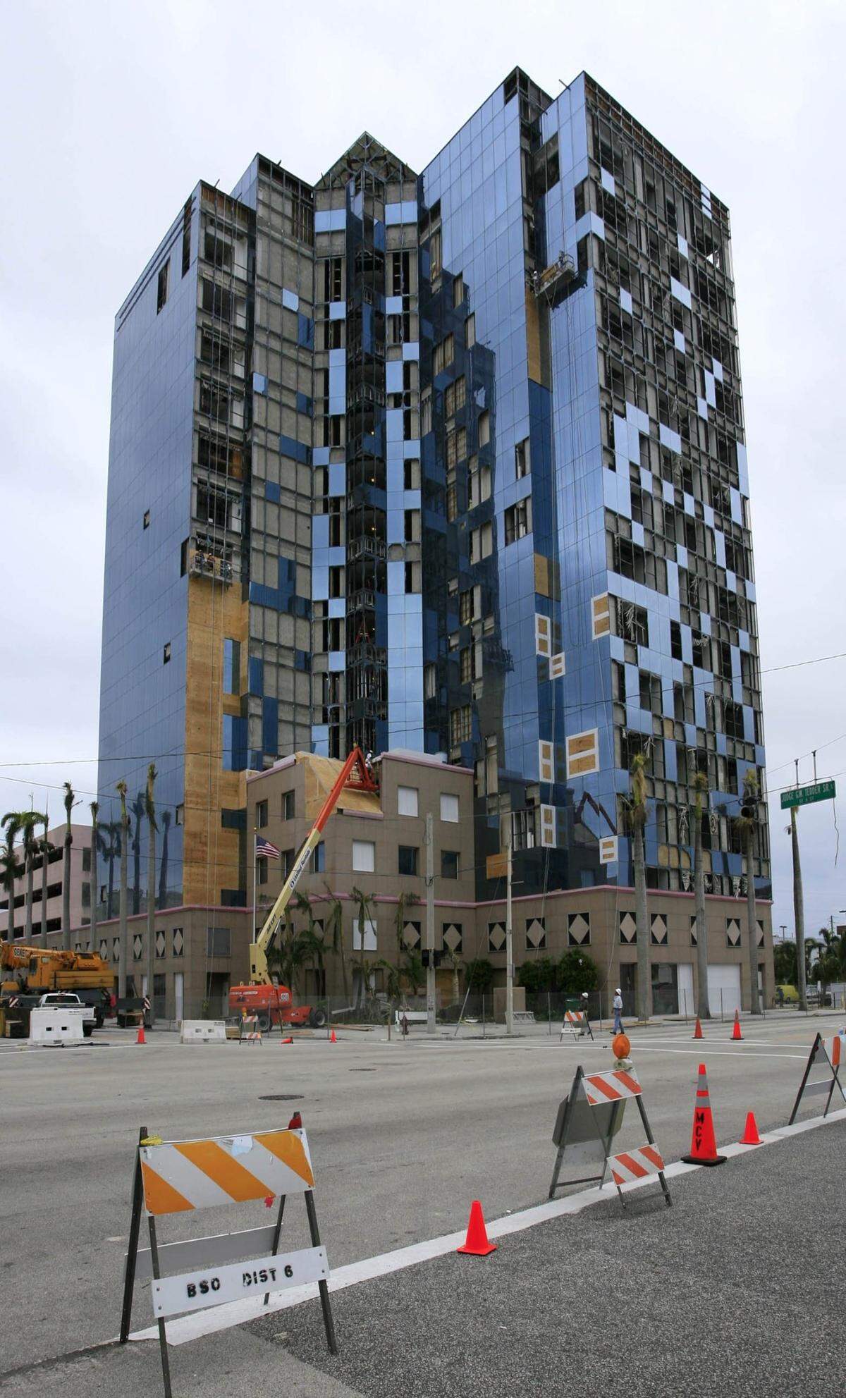 Workers board up the Broward County School Board building in Fort Lauderdale after it took a hit from Hurricane Wilma.