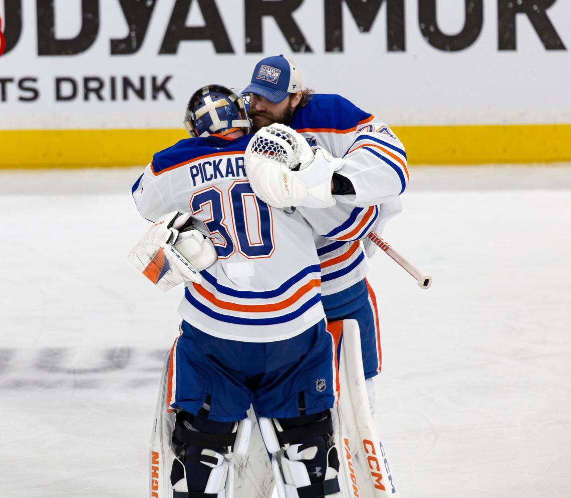 Edmonton Oilers goaltenders Calvin Pickard (30) and Stuart Skinner (74) celebrate after a 5-4 overtime win against the Florida Panthers in Game 4 of the NHL Stanley Cup Final at Amerant Bank Arena on Thursday, June 12, 2025, in Sunrise, Fla.