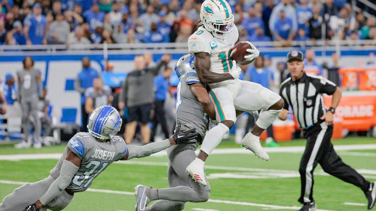 Miami Dolphins wide receiver Tyreek Hill (10) catches a first down pass as Detroit Lions cornerback Amani Oruwariye (24) defends in the second quarter at Ford Field in Detroit, Michigan on Sunday, October 30, 2022.