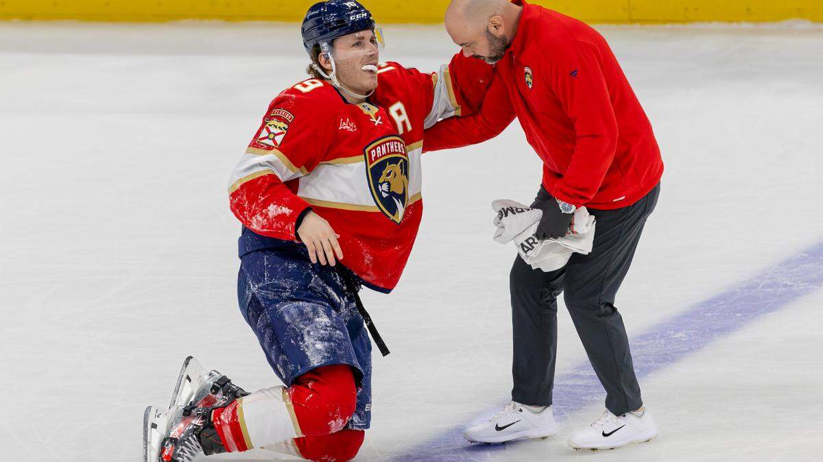 Florida Panthers left-wing Matthew Tkachuk (19) is helped off the ice by a team trainer after being injured from a hit by Tampa Bay Lightning right-wing Nikita Kucherov (86) during the first period of an NHL game at Amerant Bank Arena on Monday, Dec. 23, 2024, in Sunrise, Florida.