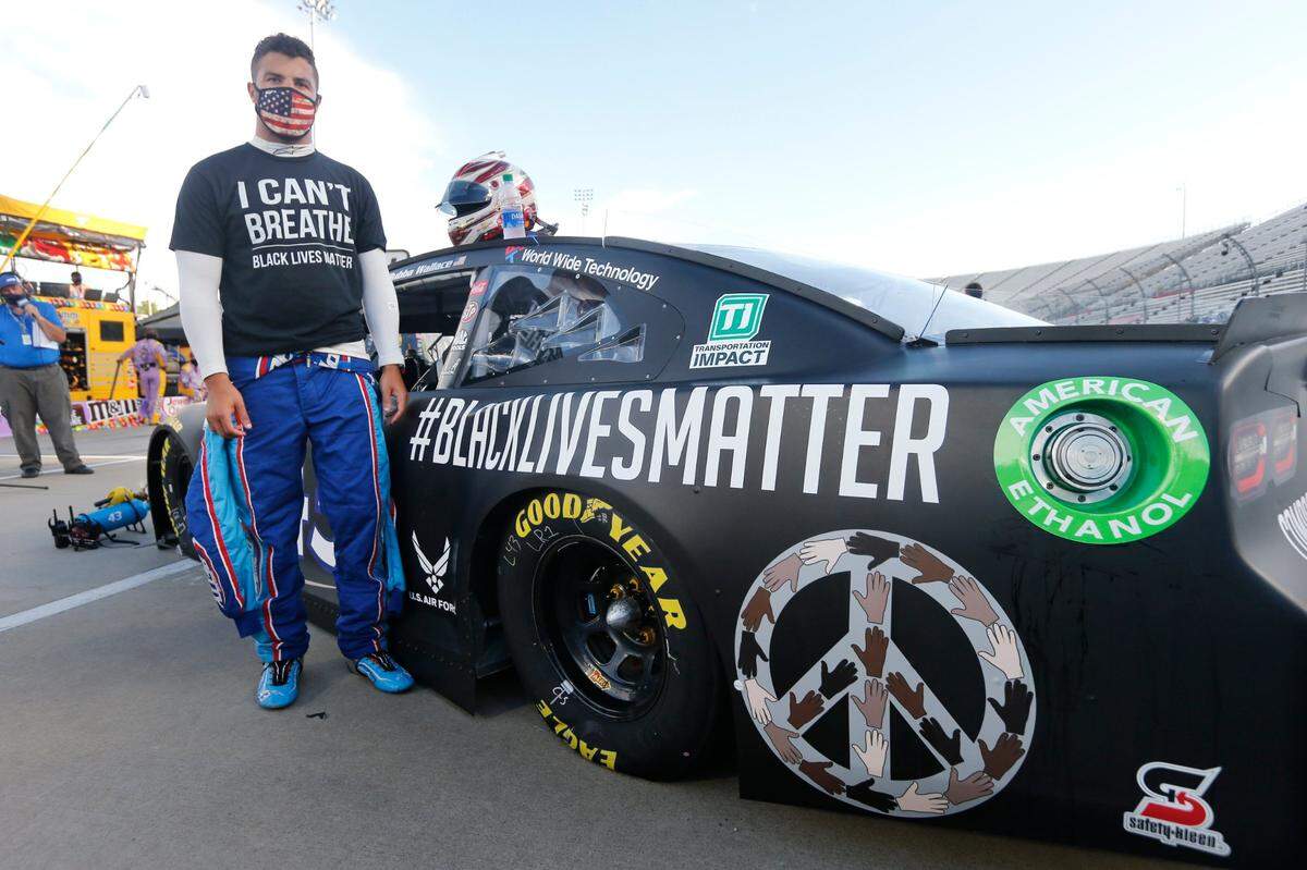 FILE - In this June 10, 2020, file photo, driver Bubba Wallace waits for the start of a NASCAR Cup Series auto race in Martinsville, Va. Bubba Wallace now counts Spike Lee and Demi Lovato – his admitted celebrity crush – as those loudly in his corner since he’s become the leader of NASCAR’s push for change. (AP Photo/Steve Helber, File)