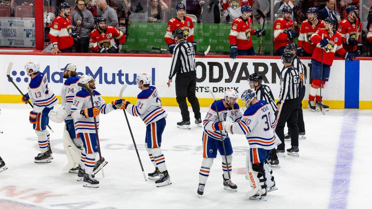 Edmonton Oilers center Connor McDavid (97) and goaltender Calvin Pickard (30) celebrate with teammates after a 5-4 overtime victory against the Florida Panthers in Game 4 of the Stanley Cup Final at Amerant Bank Arena on Thursday, June 12, 2025, in Sunrise, Fla.