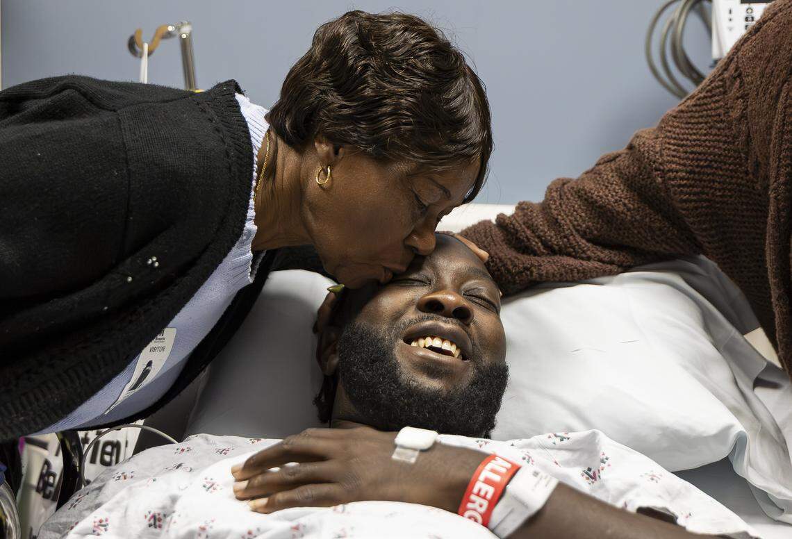 Chevon Byfield, 39, who suffers from heart failure and relies on a left ventricular assist device (LVAD), is kissed by his grandmother, Brylon Brown, before heading to a procedure at Memorial Regional Hospital on Tuesday, Feb. 3, 2026, in Hollywood, Fla. After waiting more than six years for a transplant, Byfield checked into the hospital for the fourth time Tuesday to undergo a quarterly procedure and remain on-site until a compatible heart becomes available.