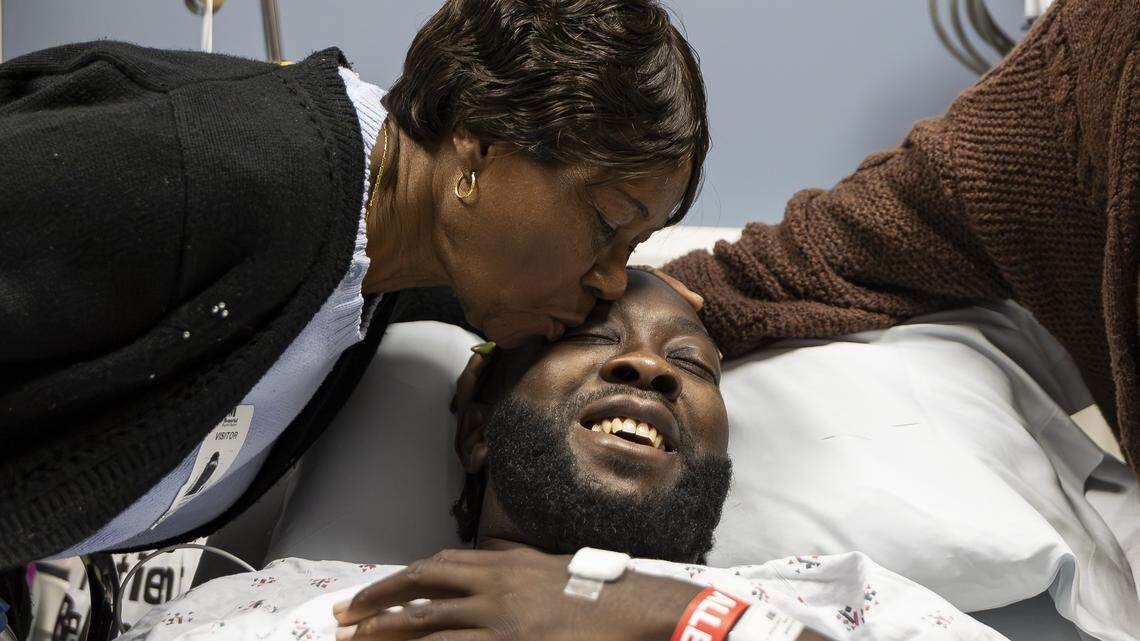 Chevon Byfield, 39, who suffers from heart failure and relies on a left ventricular assist device (LVAD), is kissed by his grandmother, Brylon Brown, before heading to a procedure at Memorial Regional Hospital on Tuesday, Feb. 3, 2026, in Hollywood, Fla. After waiting more than six years for a transplant, Byfield checked into the hospital for the fourth time Tuesday to undergo a quarterly procedure and remain on-site until a compatible heart becomes available.
