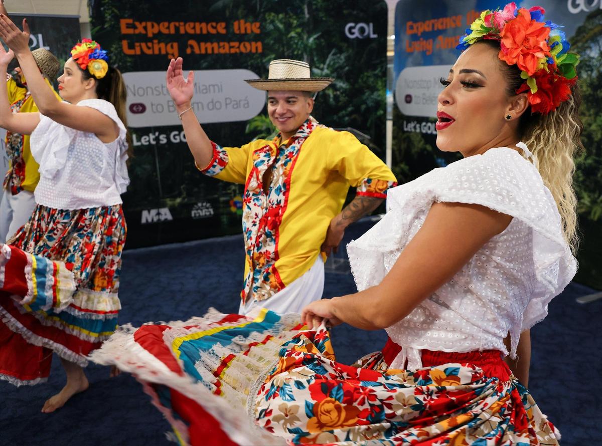 Brazilian Carnival dancers Ingra Sancho, Oscar Barrera, and Lais Lopes, right, perform during the Gol’s even to celebrate the new flights connecting Miami to Belem, Brazil on Thursday, June 26, 2025, at Miami International Airport.
