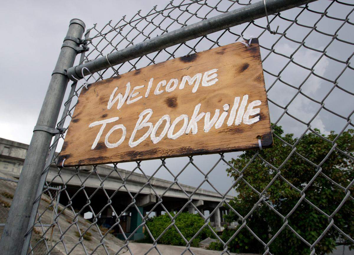 A welcome sign at a camp for sexual offenders living under the Julia Tuttle Causeway was named after Ron Book, the head of Miami-Dade County Homeless Trust, who was criticized by the campers for his role in enacting restrictions on where they could live.