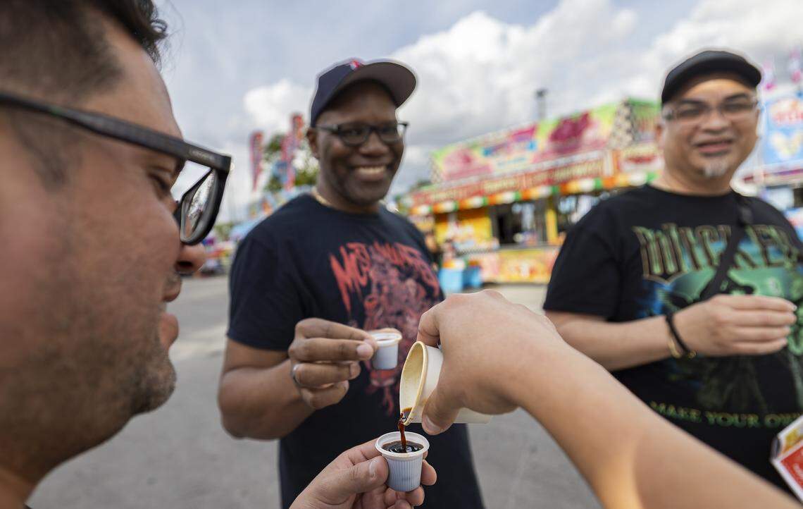Luis Genovez, left, shares a colada during the opening day of the 74th annual Miami-Dade County Youth Fair on Thursday, March 12, 2026, in Miami, Fla.