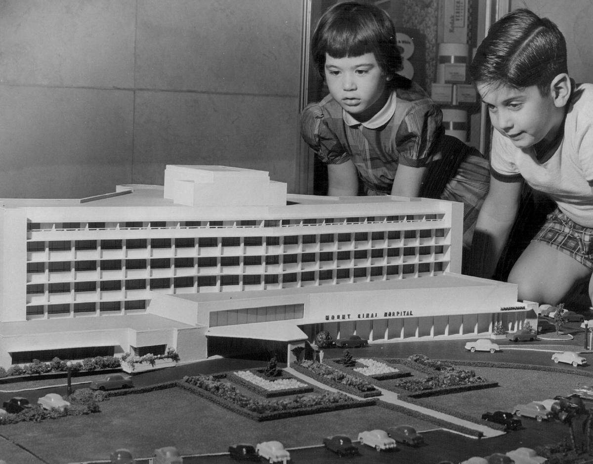 In 1955, looking over the model of the future Mount Sinai Hospital in Miami Beach are Rose Rogone and Mike Sampson both 5 years old.