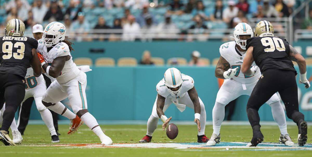 Miami Dolphins quarterback Tua Tagovailoa (1) recovers a loose ball in the first half of his NFL game against the New Orleans Saints at Hard Rock Stadium on Sunday, Nov. 30, 2025, in Miami Gardens, Fla.