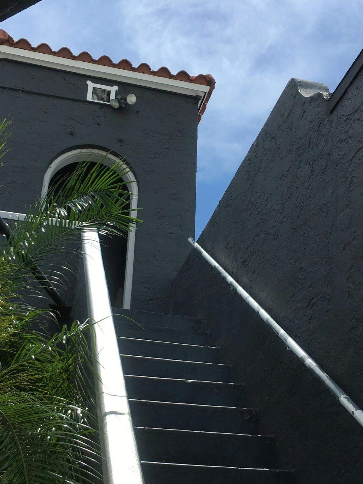 A detail of the LaSalle Cleaners building on LeJeune Road in Coral Gables shows the original staircase and a portion of the arched open upstairs gallery.