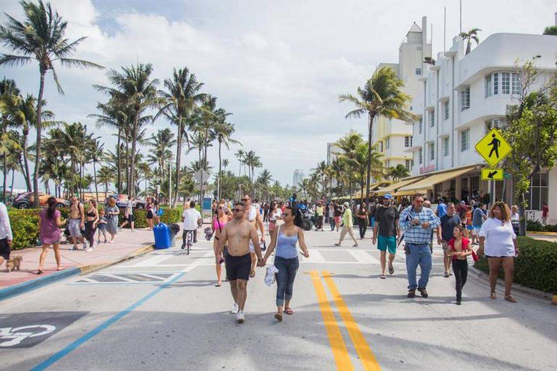 Rainy weather led to smaller crowds in Miami Beach over Memorial Day weekend in 2018. Here, visitors take advantage of a break in the storm to walk down Ocean Drive.