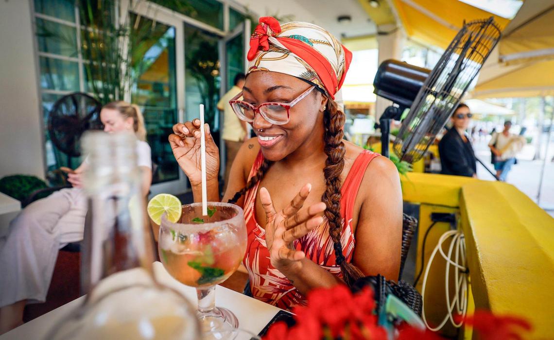 Fernie Humphrey of Boston reacts while drinking a watermelon and basel margarita at the La Trattoria restaurant at the Leslie hotel along Ocean Drive during spring break on Miami Beach, Florida on Saturday, March 15, 2025.
