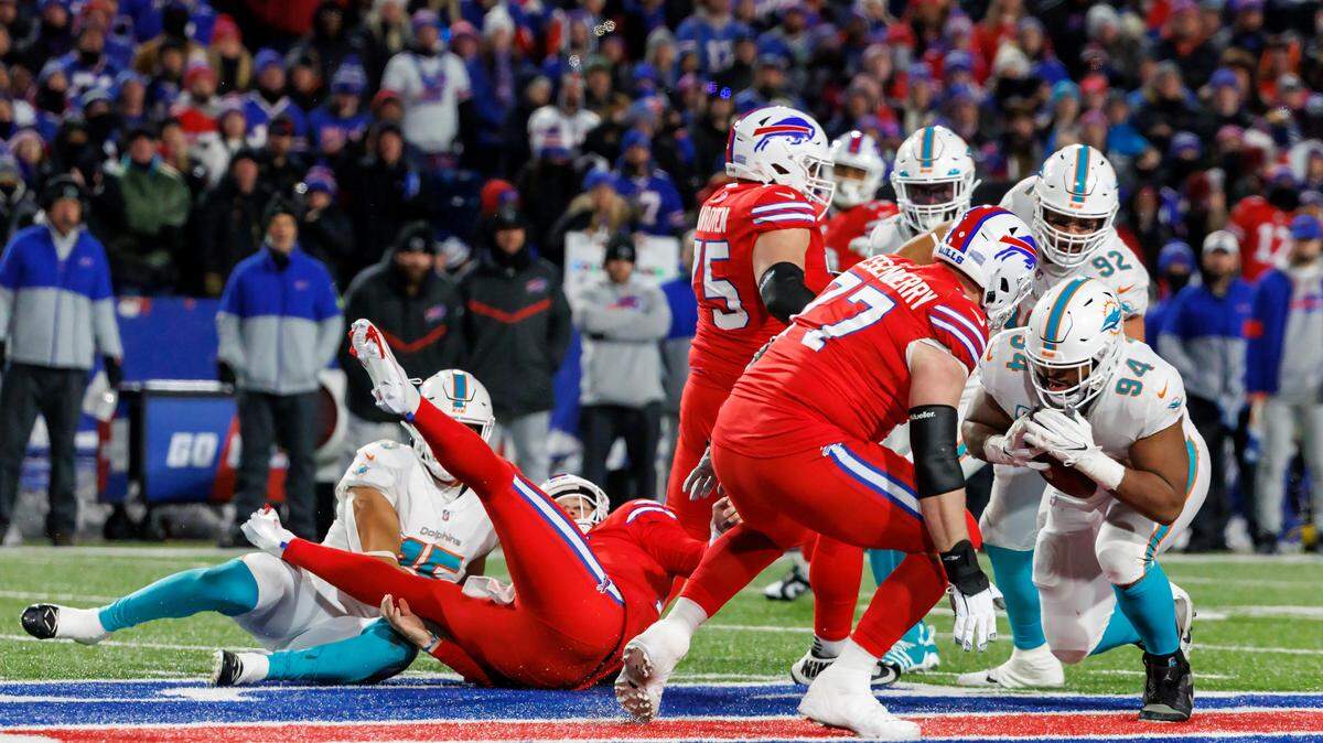 Miami Dolphins defensive tackle Christian Wilkins (94) recover a fumble after teammate Dolphins linebacker Jaelan Phillips (15) strip-sacked Buffalo Bills quarterback Josh Allen (17) during fourth quarter of an NFL football game at Highmark Stadium on Saturday, December 17, 2022 in Orchard Park, New York.