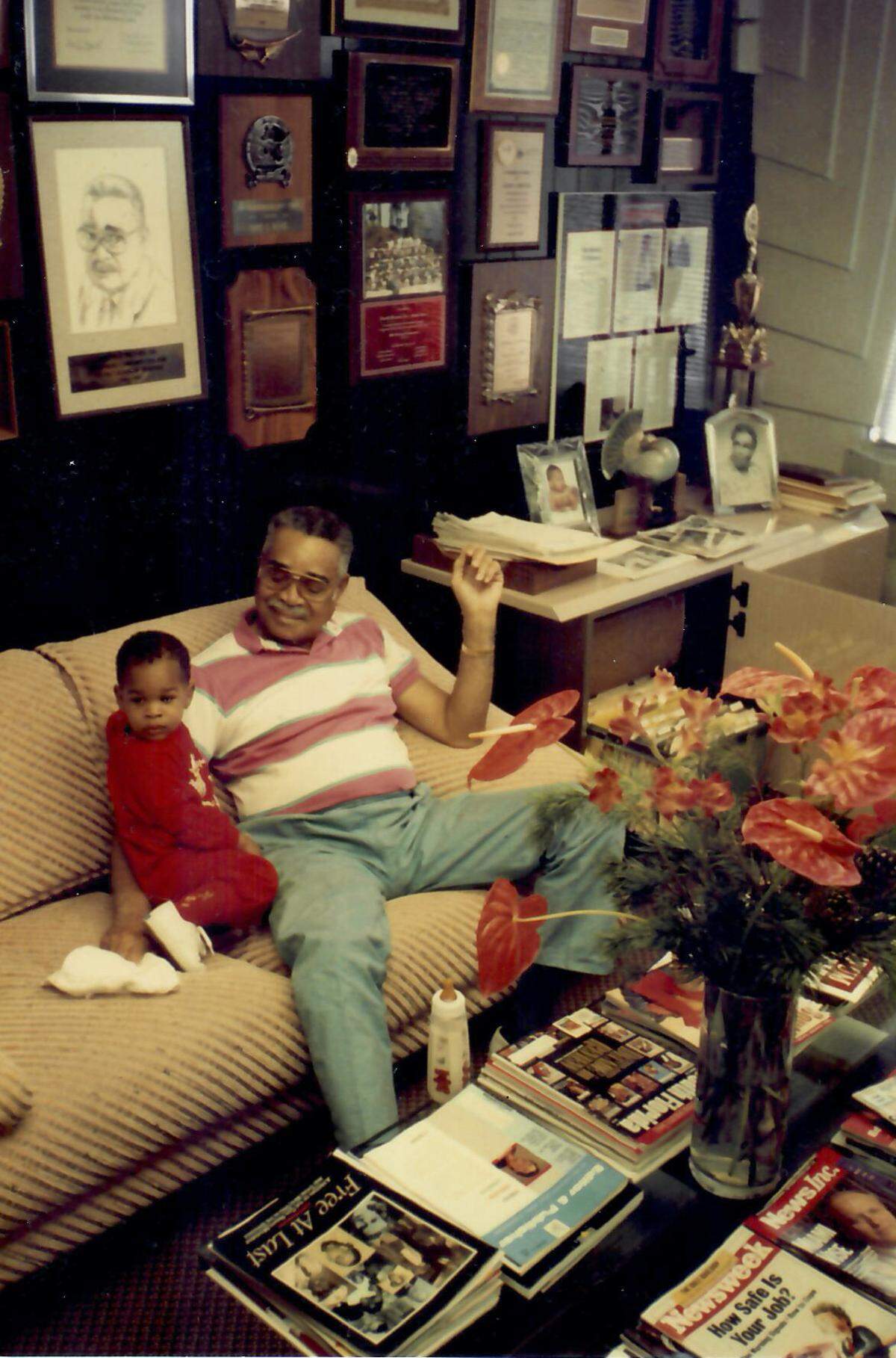 A young Garth Reeves III plays with his grandfather Garth Sr. at The Miami Times office. His mother, Rachel, would succeed his grandfather as publisher in 1994 before she handed over control to the youngest Reeves in 2017.