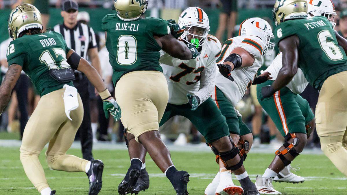Miami Hurricanes offensive lineman Anez Cooper (73) works to stop South Florida Bulls defensive tackle Doug Blue-Eli (0) in the first half of their NCAA college football game at the Raymond James Stadium on Saturday, Sept. 21, 2024, in Tampa, Fla.