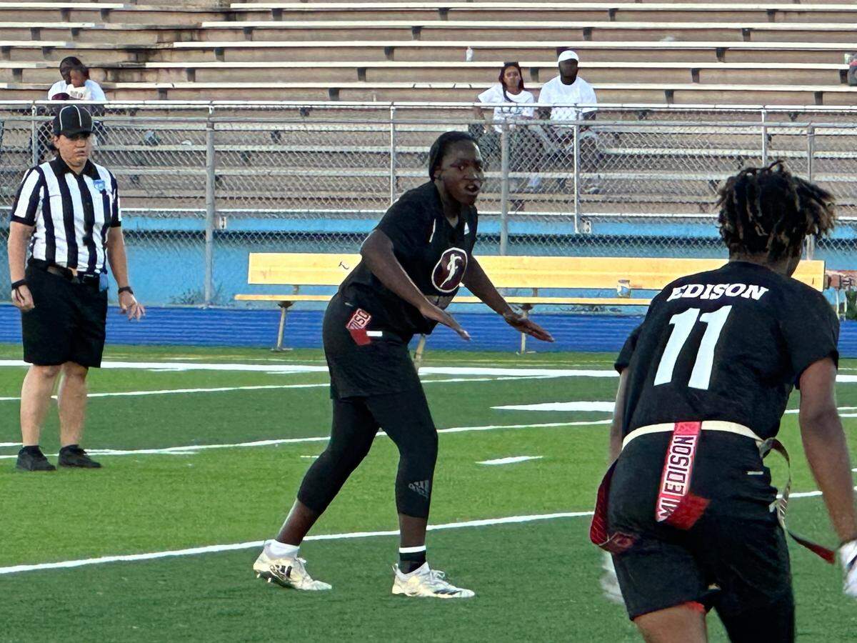 Miami Edison quarterback Alexandra Harris calls out a play during Thursday’s GMAC championship game against Miami Central. The Red Raiders won 21-7.