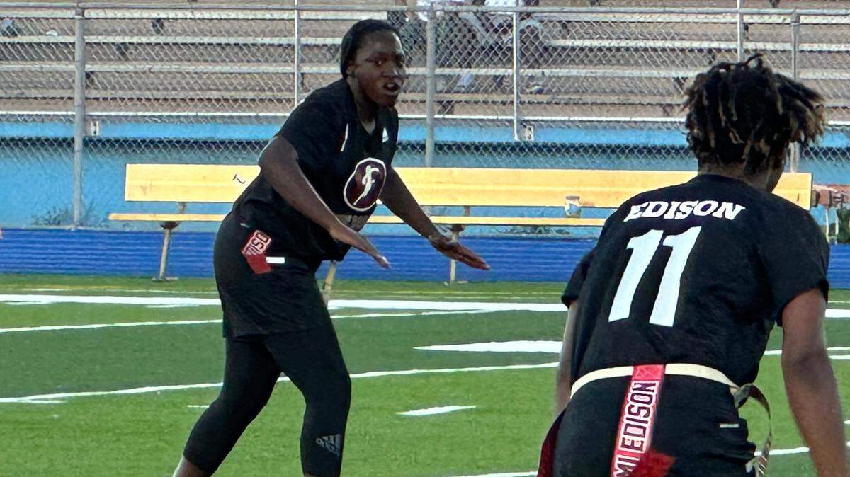 Miami Edison quarterback Alexandra Harris calls out a play during Thursday’s GMAC championship game against Miami Central. The Red Raiders won 21-7.