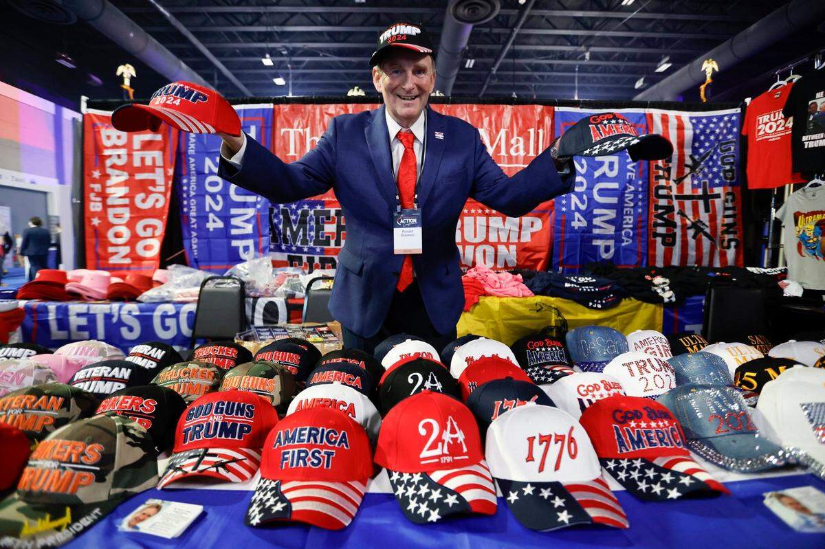Vendor, Ronald Soloman sells MAGA and patriotic products in the exhibition area during the Turning Point Action Conference at the Palm Beach County Convention Center in West Palm Beach, Florida, on Saturday, July 15, 2023.