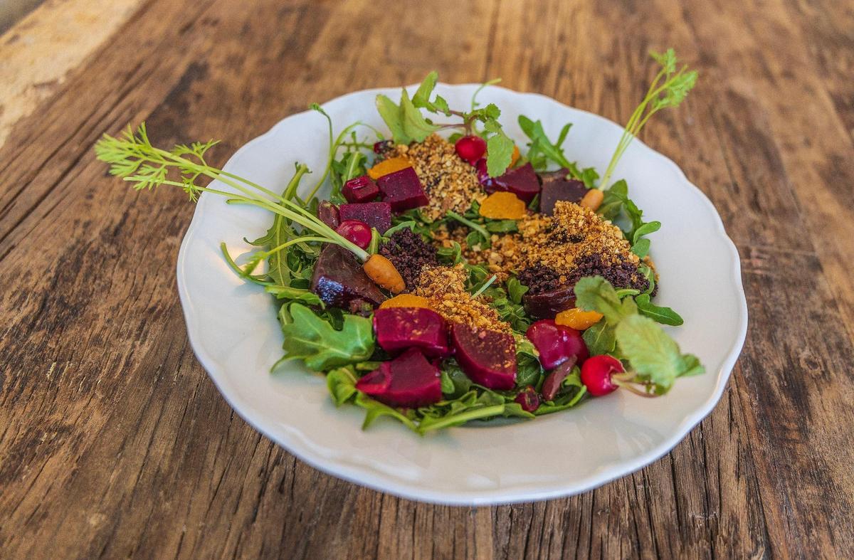 Th Beet 3 way salad at Mutra includes vegan tzatziki, pickled beets, grilled beets, beet crema, torched clementine, chermoula salsa, arugula, tiny radishes, kalamata powder and candied almonds.