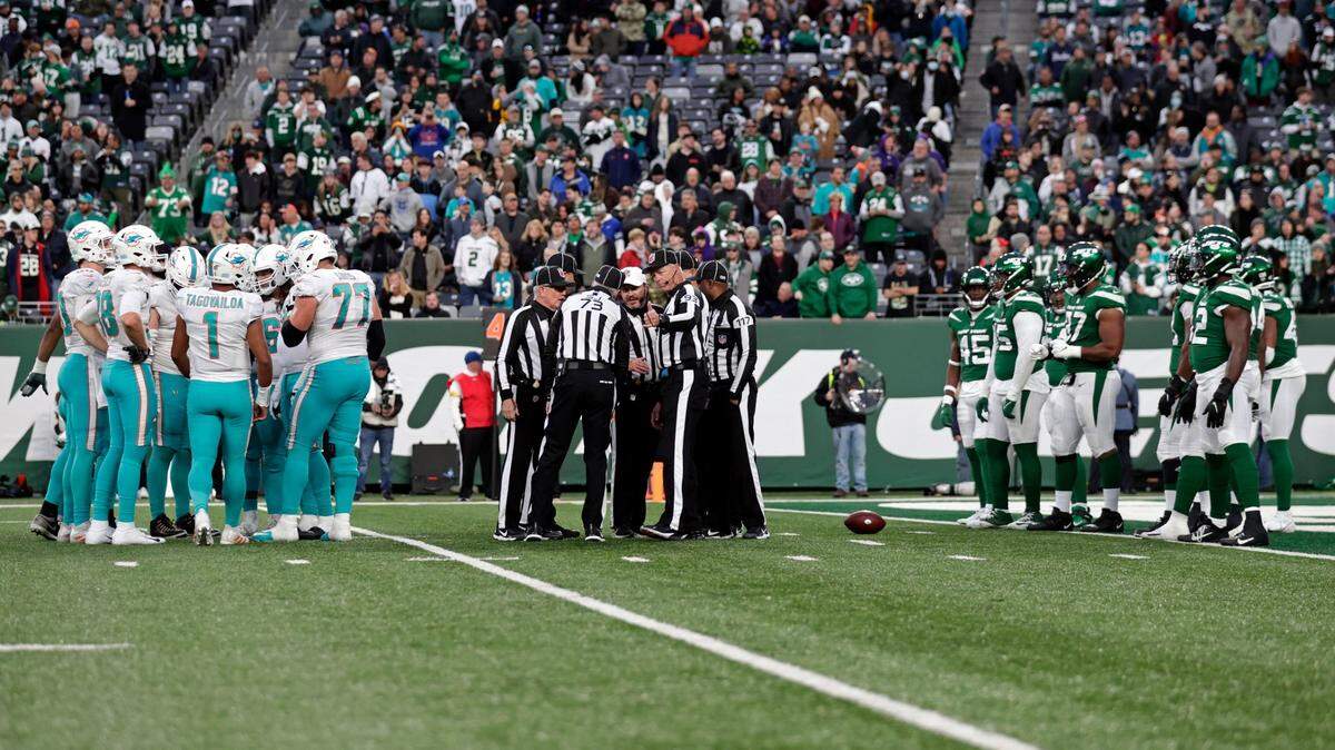 NFL Officials meet between the Miami Dolphins and the New York Jets during an NFL football game, Sunday, Nov. 21, 2021, in East Rutherford, N.J. (AP Photo/Adam Hunger)