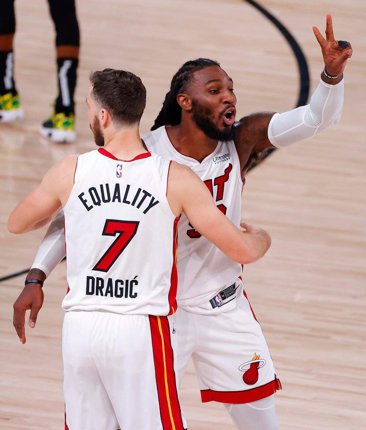 LAKE BUENA VISTA, FLORIDA - SEPTEMBER 17: Jae Crowder #99 of the Miami Heat and Goran Dragic #7 of the Miami Heat react after their win over Boston Celtics in Game Two of the Eastern Conference Finals during the 2020 NBA Playoffs at AdventHealth Arena at the ESPN Wide World Of Sports Complex on September 17, 2020 in Lake Buena Vista, Florida. NOTE TO USER: User expressly acknowledges and agrees that, by downloading and or using this photograph, User is consenting to the terms and conditions of the Getty Images License Agreement. (Photo by Kevin C. Cox/Getty Images)