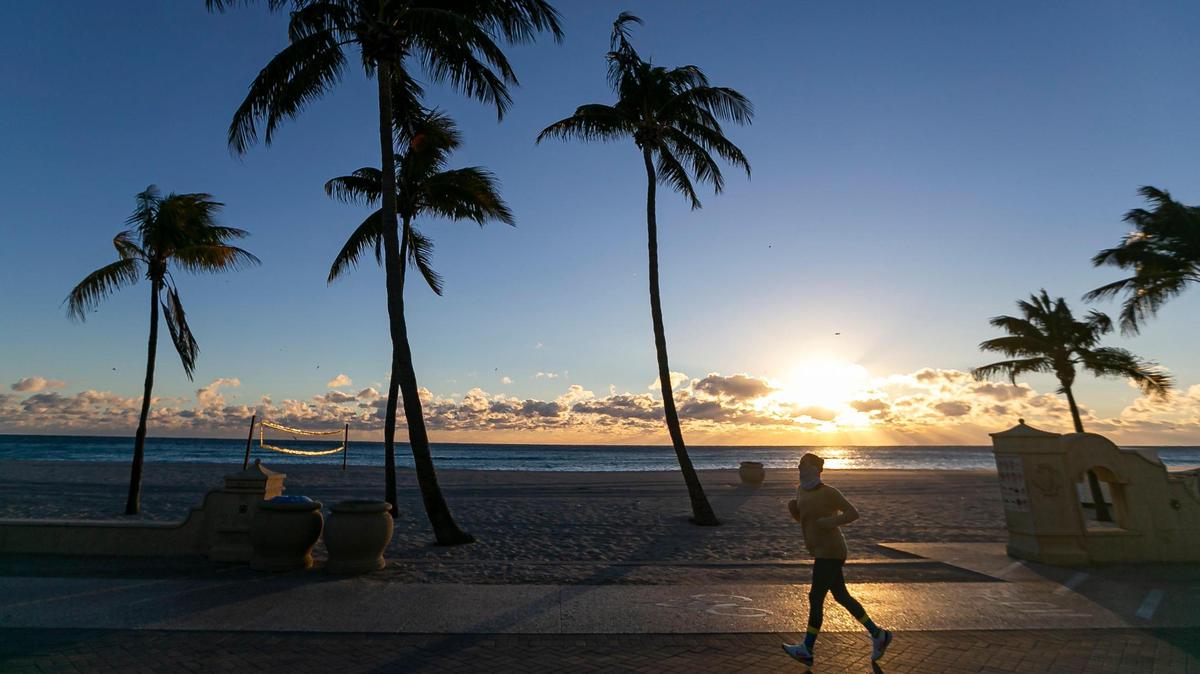 A runner makes her way down the Hollywood Beach Broadwalk as temperatures dip into the mid-40s on Saturday, Jan. 14, 2023, in Hollywood, Florida.