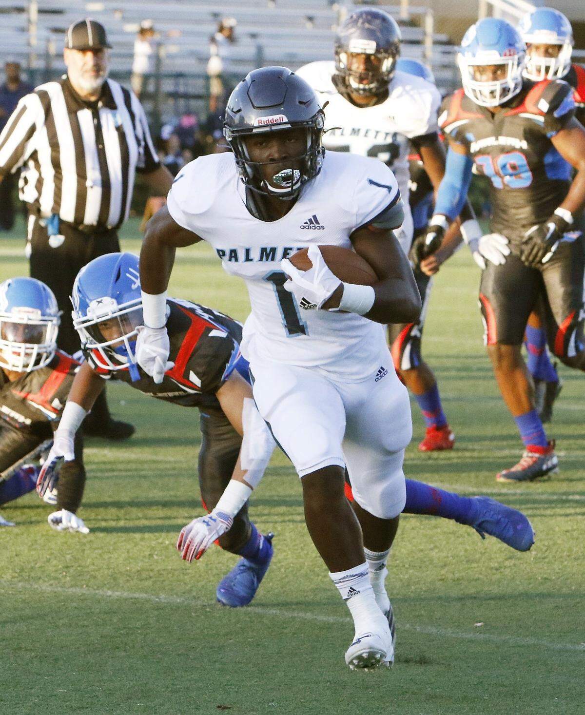 Palmetto Panthers’ Brashard Smith (1) carries the ball against Hialeah Thoroughbreds during the football game on Thursday, Sept. 5, 2019 at Milander Park Stadium in Hialeah
