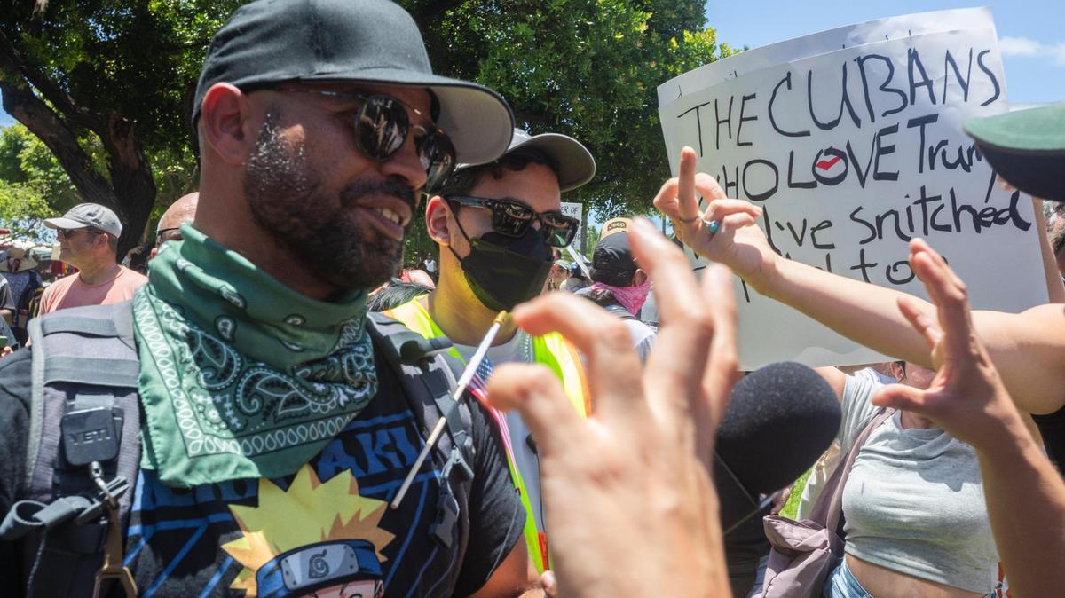 Enrique Tarrio, left, showed up at the ‘No Kings’ protest at the Torch of Friendship monument at Bayfront Park in Miami on Saturday.