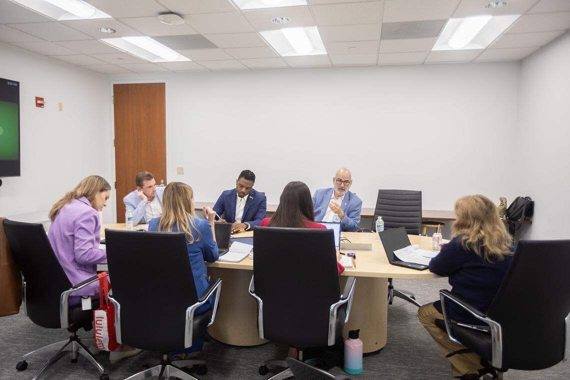 Back from left, James DeSantis, Michael Hepburn, and Emilio Gonzalez speak with the Miami Herald Editorial Board during an interview with City of Miami mayoral candidates at the Miami Herald newsroom on Monday, Oct. 6, 2025, in Miami.