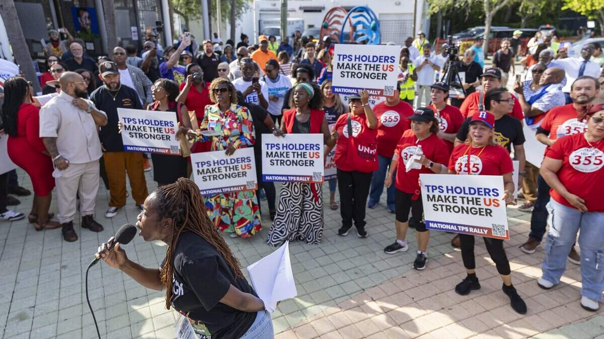 Santcha Etienne speaks during a rally at the Little Haiti Cultural Center on Thursday, July 9, 2026, in Miami, Fla. The event called for protections for Temporary Protected Status (TPS) holders and other immigrants after the Trump administration stripped many of them of legal protections against deportation.