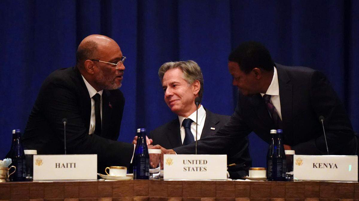 Prime Minister of Haiti Ariel Henry, left, greets Kenyan Cabinet Secretary for Foreign and Diaspora Affairs Alfred Nganga Mutua, right, before United States Secretary of State Antony Blinken addresses diplomats during a meeting on the security situation in Haiti in New York on Friday, Sept. 22, 2023. (Bing Guan/Pool Photo via AP)