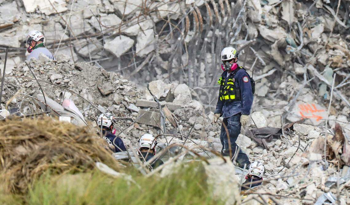 Searchers move through debris webbed wth bent rebar and broken conduit in the ruins of the Champlain Towers South condo in Surfside in July. Rusting rebar is the biggest and most expensive repair issue for many coastal condos, though its not yet clear what, if any, role corrosion played in the collapse, which left 98 people dead.