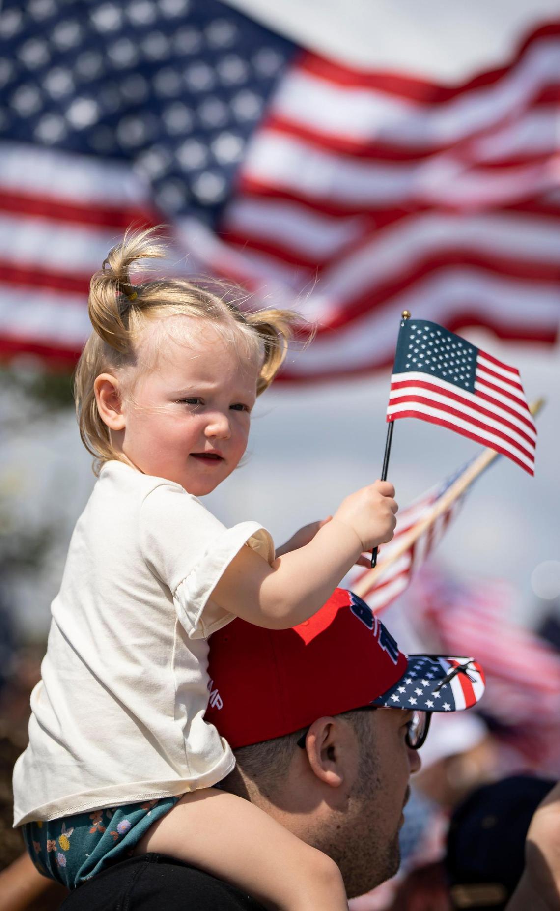 Michael Zaiss and his daughter, Violet Zaiss, 1, attend a rally before former President Donald Trump’s motorcade makes its way to Palm Beach International Airport on Monday, April 3, 2023, in West Palm Beach, Florida.