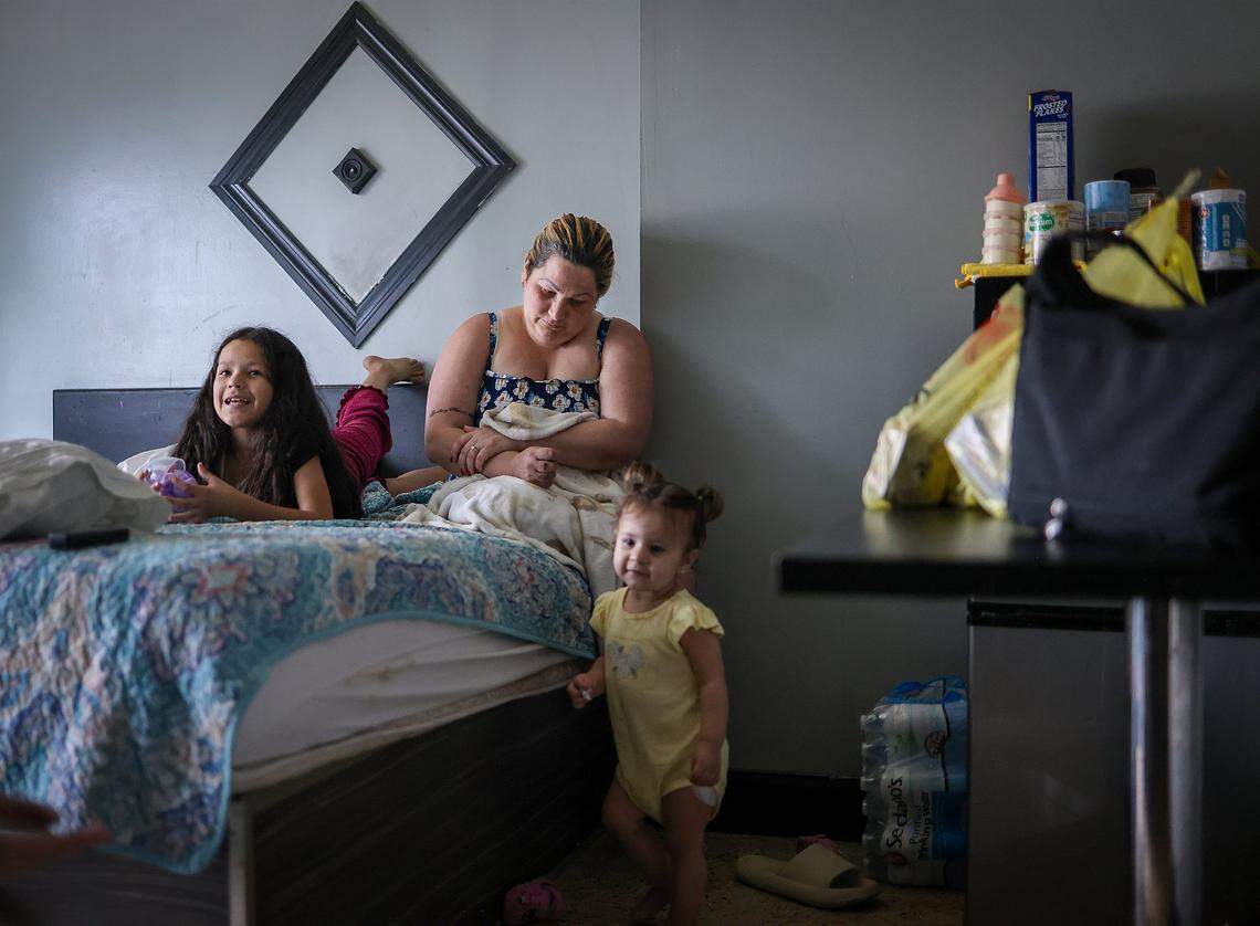 Yelitza Perez, 29, center, and her daughters, Paola, 9, left, and Itchel, 1, right, are currently staying at Ernesto Motel after an attempt to self-deport stalled when their travel documents were taken at the border several years ago while seeking asylum in the United States on Thursday, April 2, 2026, in Miami, Florida.