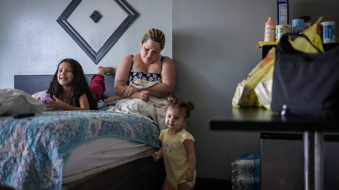 Yelitza Perez, 29, center, and her daughters, Paola, 9, left, and Itchel, 1, right, are currently staying at Ernesto Motel after an attempt to self-deport stalled when their travel documents were taken at the border several years ago while seeking asylum in the United States on Thursday, April 2, 2026, in Miami, Florida.
