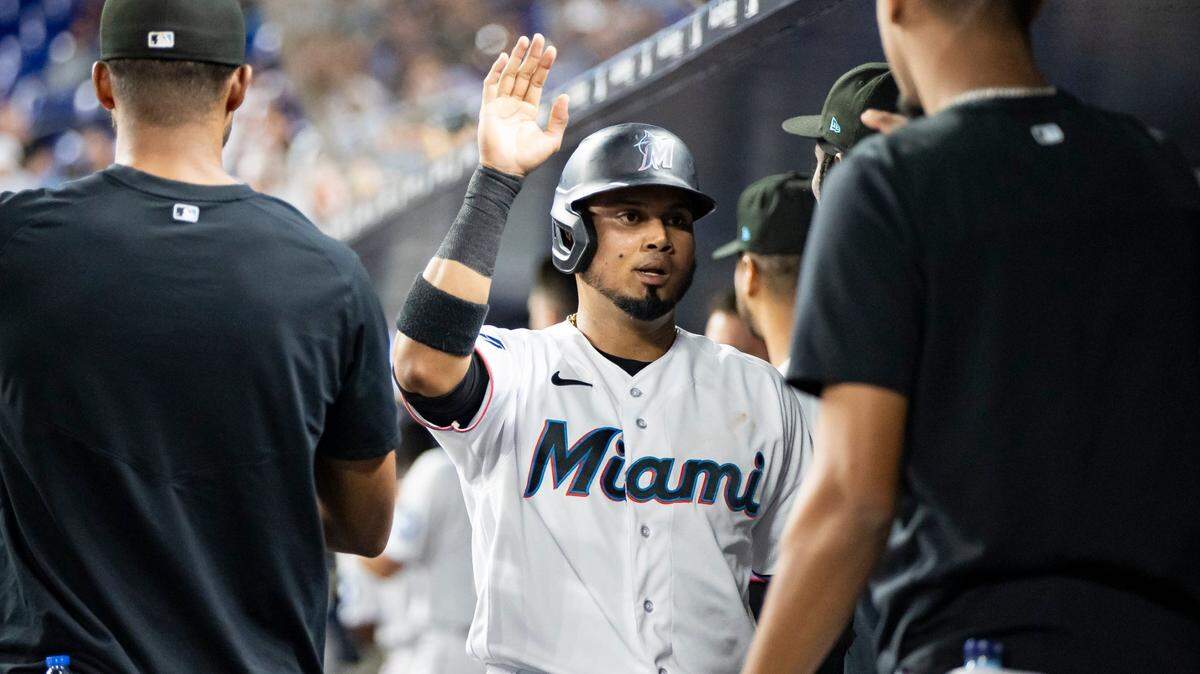 Miami Marlins second baseman Luis Arraez (3) celebrates with teammates after scoring a run against the Toronto Blue Jays in the third inning of an MLB game at loanDepot park on Monday, June 19, 2023, in Miami, Fla.