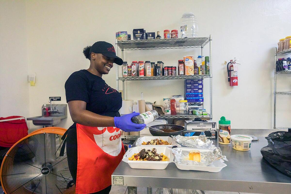 Chef Syerra Donaldson smiles as she plates meals during an event in Miami Gardens on Saturday, May 24, 2025.