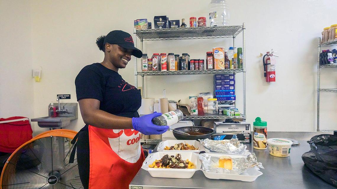 Chef Syerra Donaldson smiles as she plates meals during her EasyCookinWithSy event in Miami Gardens on Saturday, May 24, 2025. A latecomer to the culinary world, Donaldson turned her passion into a business—and a spot on the Food Network.