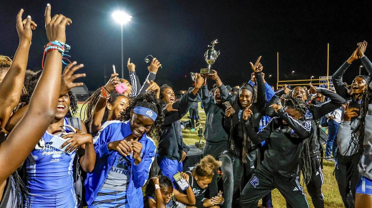 Dillard High’s Danielle Ouko-Omondi lifts the championship trophy as teammates react during the 2024 BCAA Track and Field Championship at Dillard High School in Fort Lauderdale, Florida on Friday, April 5, 2024.