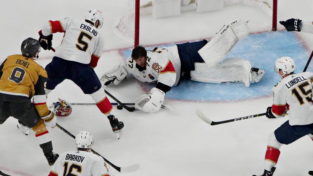 Florida Panthers goaltender Sergei Bobrovsky (72) attempts to cover the puck against the Vegas Golden Knights during the first period of an NHL hockey game Thursday, Jan. 12, 2023, in Las Vegas. (AP Photo/John Locher)