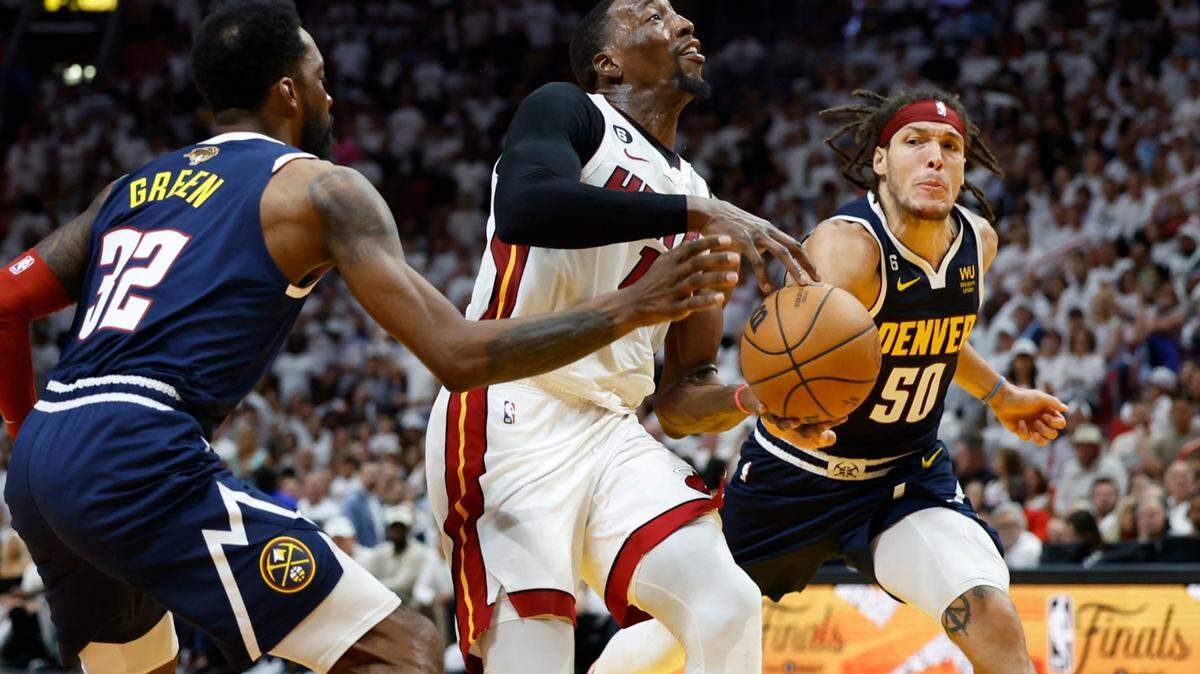 Miami Heat center Bam Adebayo (13) loses the ball as Denver Nuggets forward Jeff Green (32) and forward Aaron Gordon (50) in the fourth quarter of Game 4 of the NBA Finals at the Kaseya Center in downtown Miami, Fla. on Friday, June 9, 2023.