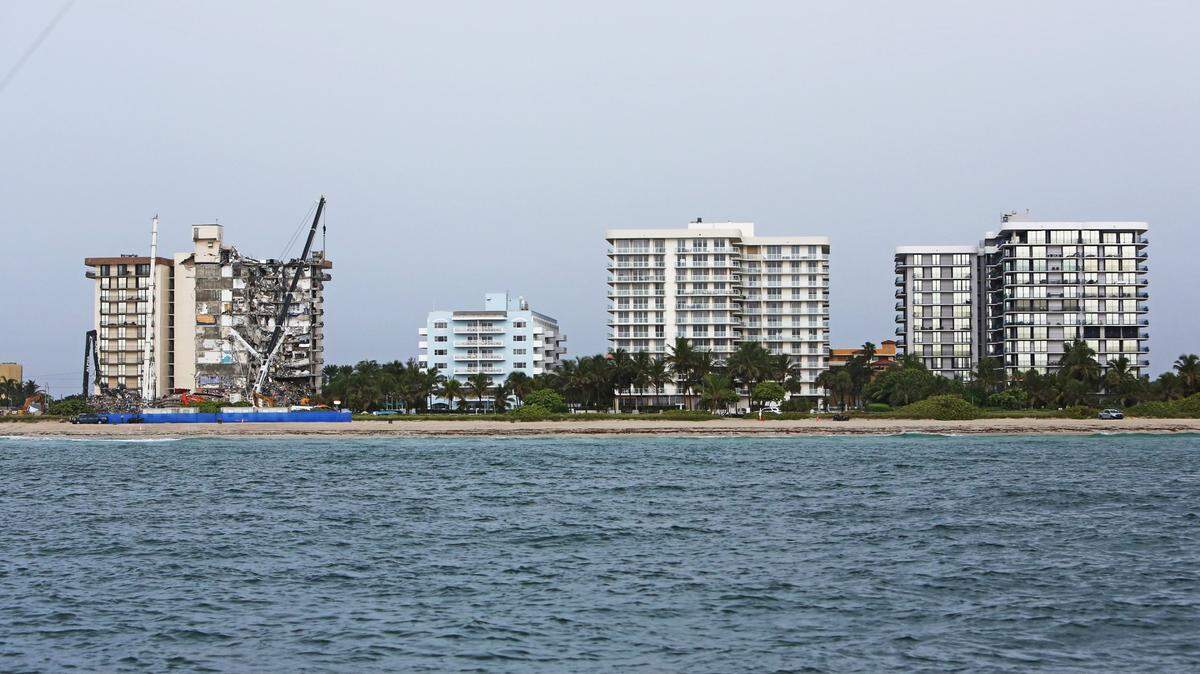 Champlain Towers South, far left, is pictured June 30, 2021, six days after it partially collapsed. Its sister buildings are Champlain Towers North, far right, and Champlain Towers East, second from right.