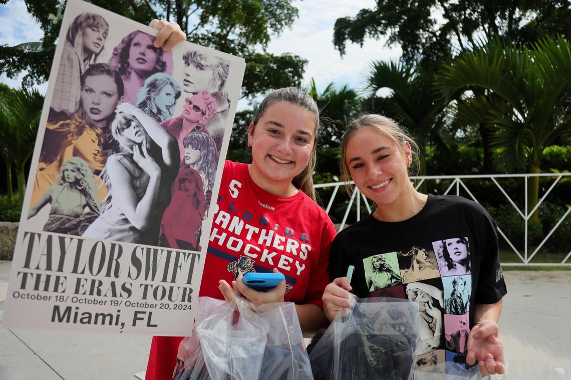 Brianna Gonzalez, 21, and Jillian Lasker, 19, are photographed with a poster and bags of clothes as they leave the Taylor Swift Eras Tour merchandise store at Hard Rock Stadium in Miami Gardens, Florida, Wednesday, October 16, 2024.